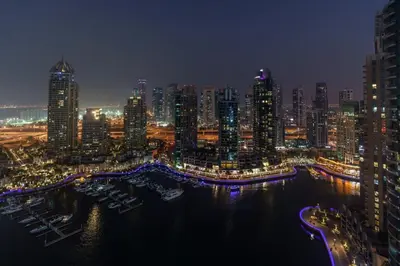 a view of a city at night with a harbor at GuestReady - Skyview Home with Marina View in Dubai