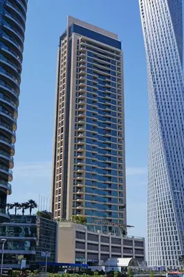 a tall building in the middle of two other buildings at GuestReady - Skyview Home with Marina View in Dubai