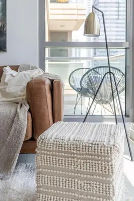a living room with a couch and a table and a lamp at GuestReady - Skyview Home with Marina View in Dubai