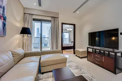 a living room with a couch and a flat screen tv at Amazing Burj Khalifa view from Brand new apartment in Dubai