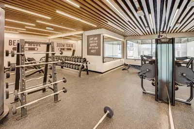 a gym with dumbbells and equipment in a building at Amazing Burj Khalifa view from Brand new apartment in Dubai