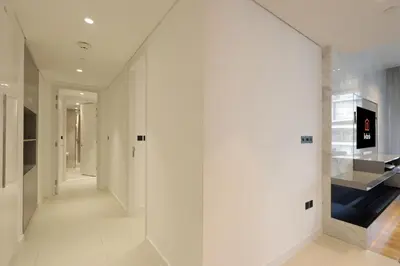 a hallway of a house with white walls at Livbnb-Upgraded 2BR plus Maid's Room with Sea View in Dubai