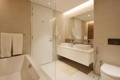 a bathroom with a sink and a toilet and a mirror at Livbnb-Upgraded 2BR plus Maid's Room with Sea View in Dubai