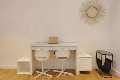 a desk with two chairs and a mirror on a wall at Livbnb-Upgraded 2BR plus Maid's Room with Sea View in Dubai