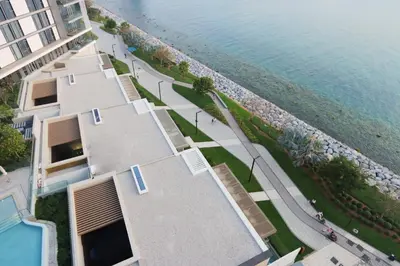 an aerial view of a building next to the water at Livbnb-Upgraded 2BR plus Maid's Room with Sea View in Dubai