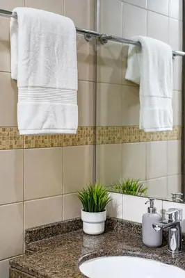 a bathroom with a sink and a mirror and towels at Cute 1BR - Dubai Marina Views - Walk 9min to Beach in Dubai