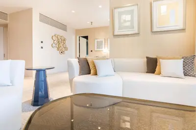 a living room with a white couch and a table at Maison Privee - Luxury Sea View Apt in FIVE Resort on The Palm in Dubai