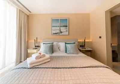 a bedroom with a large bed with towels on it at Maison Privee - Luxury Sea View Apt in FIVE Resort on The Palm in Dubai