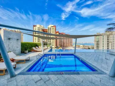 a swimming pool on the roof of a building at Palm Tower where Luxury & View meet in one place in Dubai
