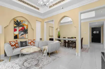 a living room with a couch and a table at Maison Privee - Elite Apt Connected to Dubai Mall & Burj Khalifa in Dubai