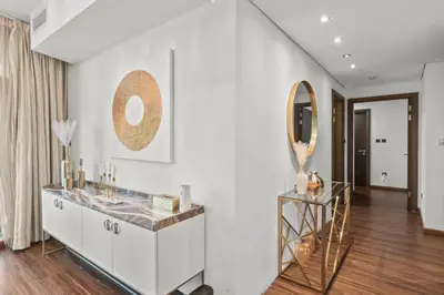 a white room with a mirror and a dresser at The Lofts - Luxurious space with Burj Khalifa View in Dubai