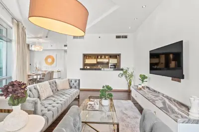 a living room with a couch and a table at The Lofts - Luxurious space with Burj Khalifa View in Dubai