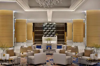 a lobby with couches and chairs and a table at Marriott Resort Palm Jumeirah, Dubai in Dubai