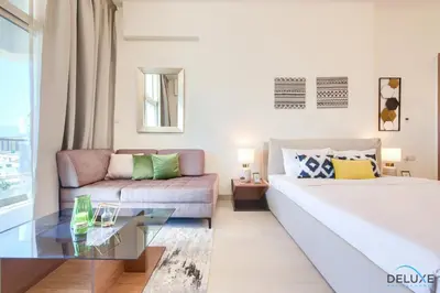 a living room with a bed and a couch at Perfect Studio Getaway Next to the Iconic Creek Harbour, Azizi Aliyah, Al Jaddaf, by Deluxe Holiday Homes in Dubai