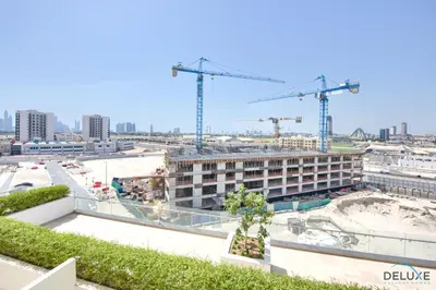 a view of a building under construction with cranes at Perfect Studio Getaway Next to the Iconic Creek Harbour, Azizi Aliyah, Al Jaddaf, by Deluxe Holiday Homes in Dubai