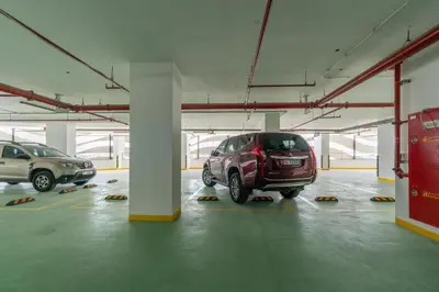 a parking garage with two cars parked in it at GlobalStay Business Bay Waves Tower Apartments Dubai in Dubai