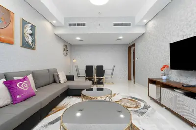 a living room with a couch and a tv at GlobalStay Business Bay Waves Tower Apartments Dubai in Dubai