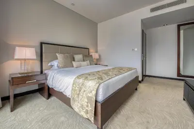 a large bedroom with a large bed and a table at Graceful 1BR at The Address Residences Dubai Marina by Deluxe Holiday Homes in Dubai