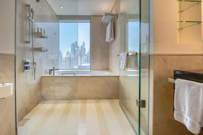 a bathroom with a shower and a sink and a tub at Graceful 1BR at The Address Residences Dubai Marina by Deluxe Holiday Homes in Dubai
