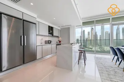 a kitchen with a stainless steel refrigerator and a counter at Fascinating Views! Large 4BR Private Beach Access, Emaar BeachFront in Dubai