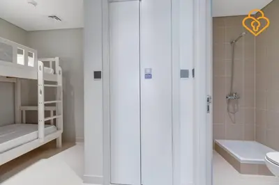 a bathroom with a shower and a toilet and a sink at Fascinating Views! Large 4BR Private Beach Access, Emaar BeachFront in Dubai