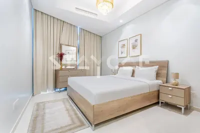 a white bedroom with a large bed and a window at Staycae Holiday Homes - Paramount Midtown in Dubai