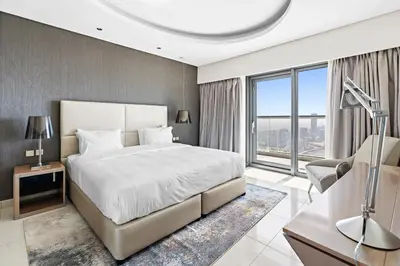 a bedroom with a large bed and a large window at ALiving Elegant 1BR I Burj Khalifa View I Paramount Towers- 6103 in Dubai