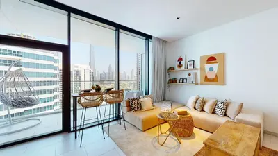 a living room with a couch and a large window at Stylish Studio with Burj Khalifa View in Dubai
