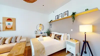 a bedroom with a bed and a couch at Stylish Studio with Burj Khalifa View in Dubai