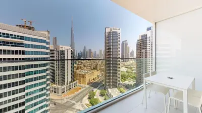 a room with a white table and a view of a city at Stylish Studio with Burj Khalifa View in Dubai