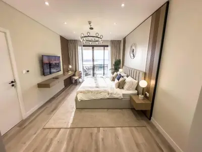 a bedroom with a large bed and a large mirror at Fabulous 1 bedroom apartment at 5 Star Resort in Dubai
