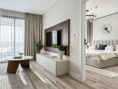 a bedroom with a large bed and a table at Fabulous 1 bedroom apartment at 5 Star Resort in Dubai