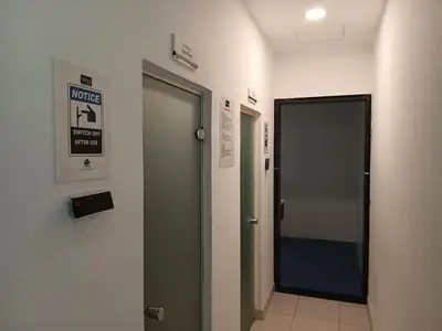 a hallway with a door and a sign on a wall at DUBAI - Glitz 3 Residences - MAJESTIC Luxe Holiday Home - 2BR - Sleep 4 - FOR FAMILIES & COUPLES STAYS ONLY in Dubai