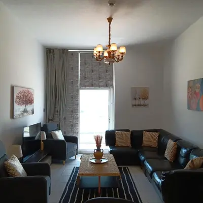 a living room with a couch and a table at DUBAI - Glitz 3 Residences - MAJESTIC Luxe Holiday Home - 2BR - Sleep 4 - FOR FAMILIES & COUPLES STAYS ONLY in Dubai