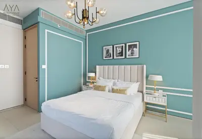 a bedroom with a large white bed and a chandelier at Jumeirah Gate Tower 1 - Stylish Apartment with Pool & City Views By ĀYA Boutique in Dubai