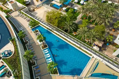 an overhead view of a swimming pool at a resort at Jumeirah Gate Tower 1 - Stylish Apartment with Pool & City Views By ĀYA Boutique in Dubai