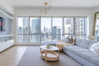 a living room with a couch and a table at GuestReady - Upscale Modern Apt in Downtown in Dubai