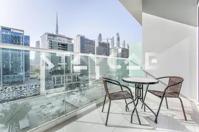 a balcony with a table and chairs in front of a window at Staycae Holiday Homes - Vera by DAMAC Near Downtown, Business Bay in Dubai