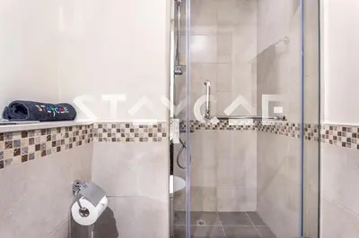 a shower with a glass door in a bathroom at Staycae Holiday Homes - Vera by DAMAC Near Downtown, Business Bay in Dubai
