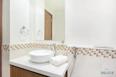a bathroom with a white sink and a mirror at Distinguished 1BR at Vera Tower Business Bay by Deluxe Holiday Homes in Dubai