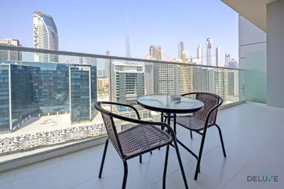 a table and two chairs on a balcony with a view at Distinguished 1BR at Vera Tower Business Bay by Deluxe Holiday Homes in Dubai