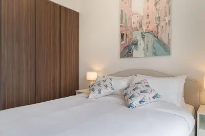 a bedroom with a white bed with two pillows at Alluring 1 BD Apartment in Business Bay with Burj Khalifa view in Dubai