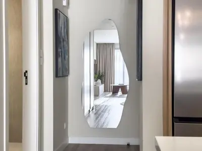 a hallway with a mirror on the wall at Relaxing 1 bedroom apartment at 5 Star Resort in Dubai