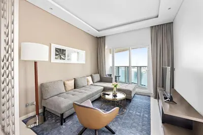 a living room with a couch and a table at ALiving Modern 1BR Apartment with Balcony & Canal View I DAMAC Maison Prive A- 517 in Dubai
