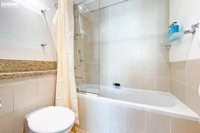 a bathroom with a toilet and a bath tub at bnbmehomes - Túria Tower A in Dubai