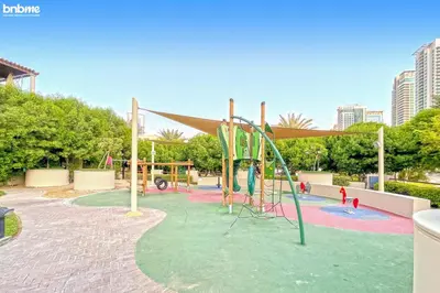 a park with a playground with a slide at bnbmehomes - Túria Tower A in Dubai
