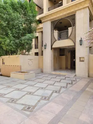a building with a courtyard in front of it at Burj Dubai Area - 5min Walk - Luxury 2 Bedroom Apartment in Dubai
