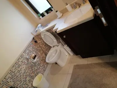 a bathroom with a toilet and a sink at Burj Dubai Area - 5min Walk - Luxury 2 Bedroom Apartment in Dubai