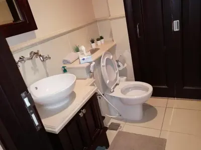 a bathroom with a white toilet and a sink at Burj Dubai Area - 5min Walk - Luxury 2 Bedroom Apartment in Dubai