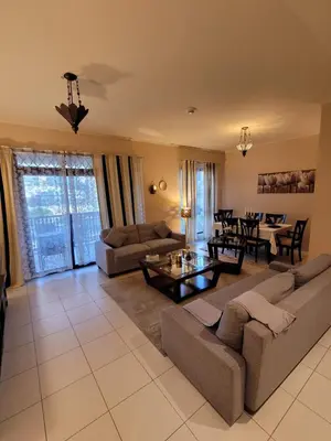a living room with a couch and a table at Burj Dubai Area - 5min Walk - Luxury 2 Bedroom Apartment in Dubai